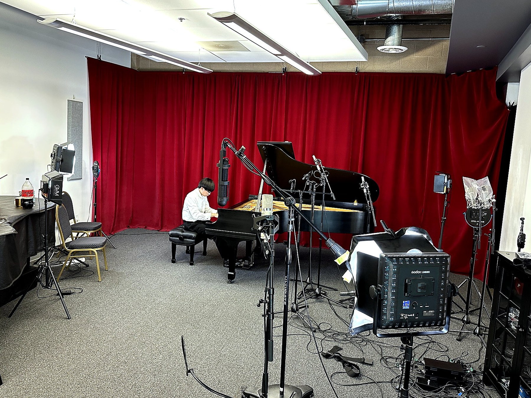 Steinway piano recording session with camera, lighting, and microphones at Mezo Records